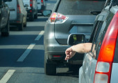 cigarette sticking out of a car windo
