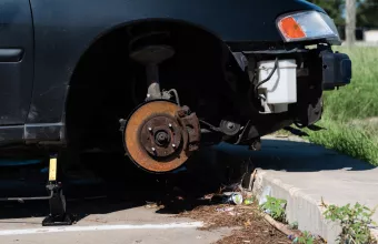 Close-up car with missing left front wheel