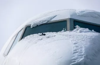 Snow covered cockpit of passenger airplane