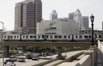 A Metro Rail light train on the Gold Line travels over the 101 Santa Ana Freeway near Union Station in Los Angeles