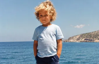 Ποιο είναι αυτό το σγουρομάλλικο ξανθό αγοράκι με τα Μούγερ και το σιέλ κοντομάνικο;