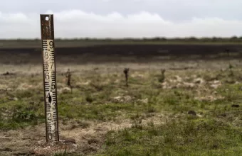 A water meter stands in a dry wetland in Donana natural park, southwest Spain