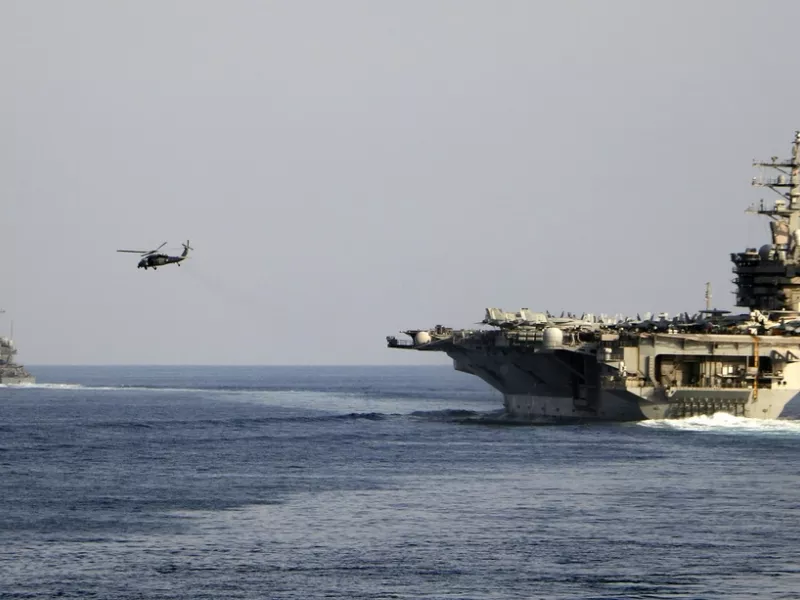 The aircraft carrier USS Dwight D. Eisenhower and other warships crosses the Strait of Hormuz